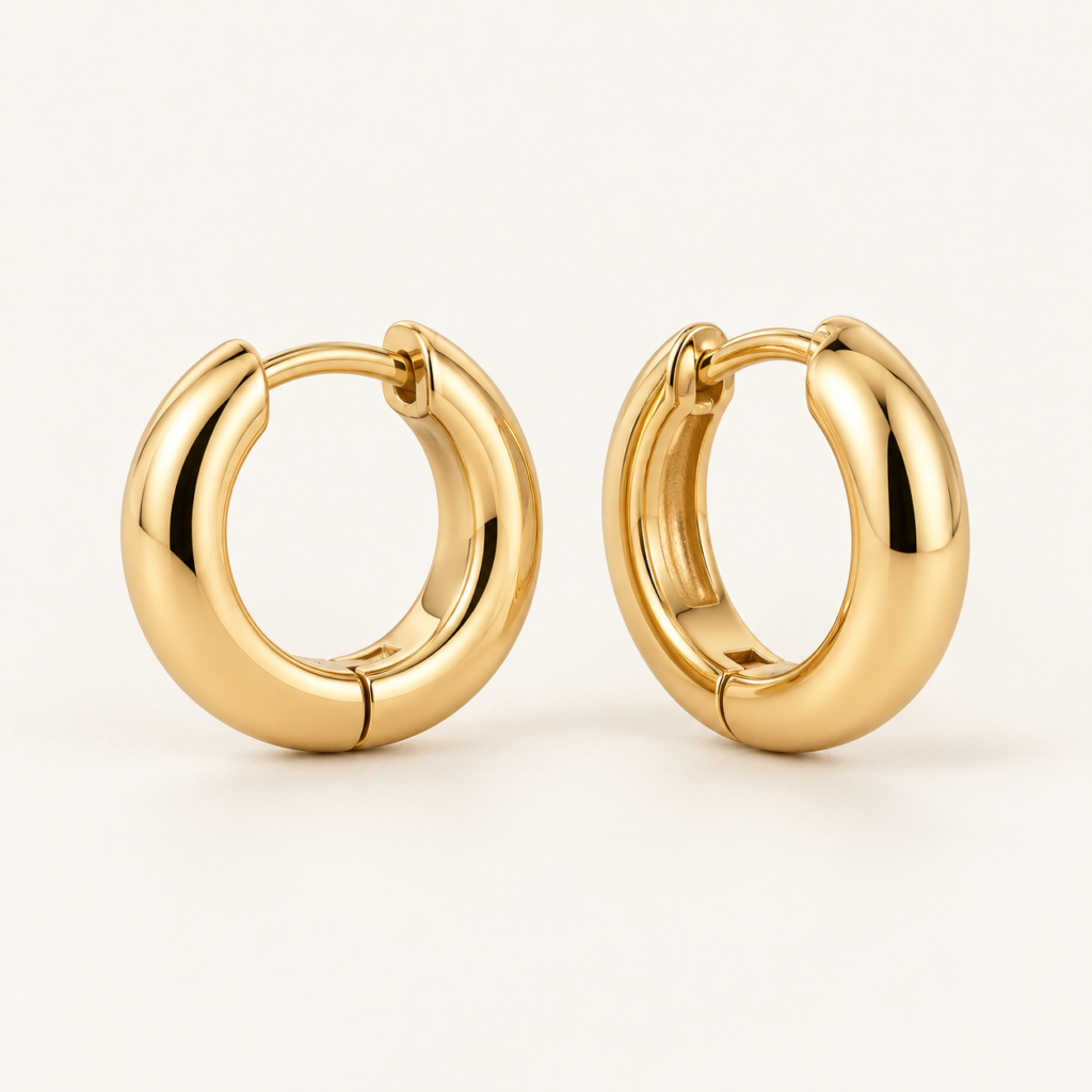 Lumière Huggie Earrings on an ivory background